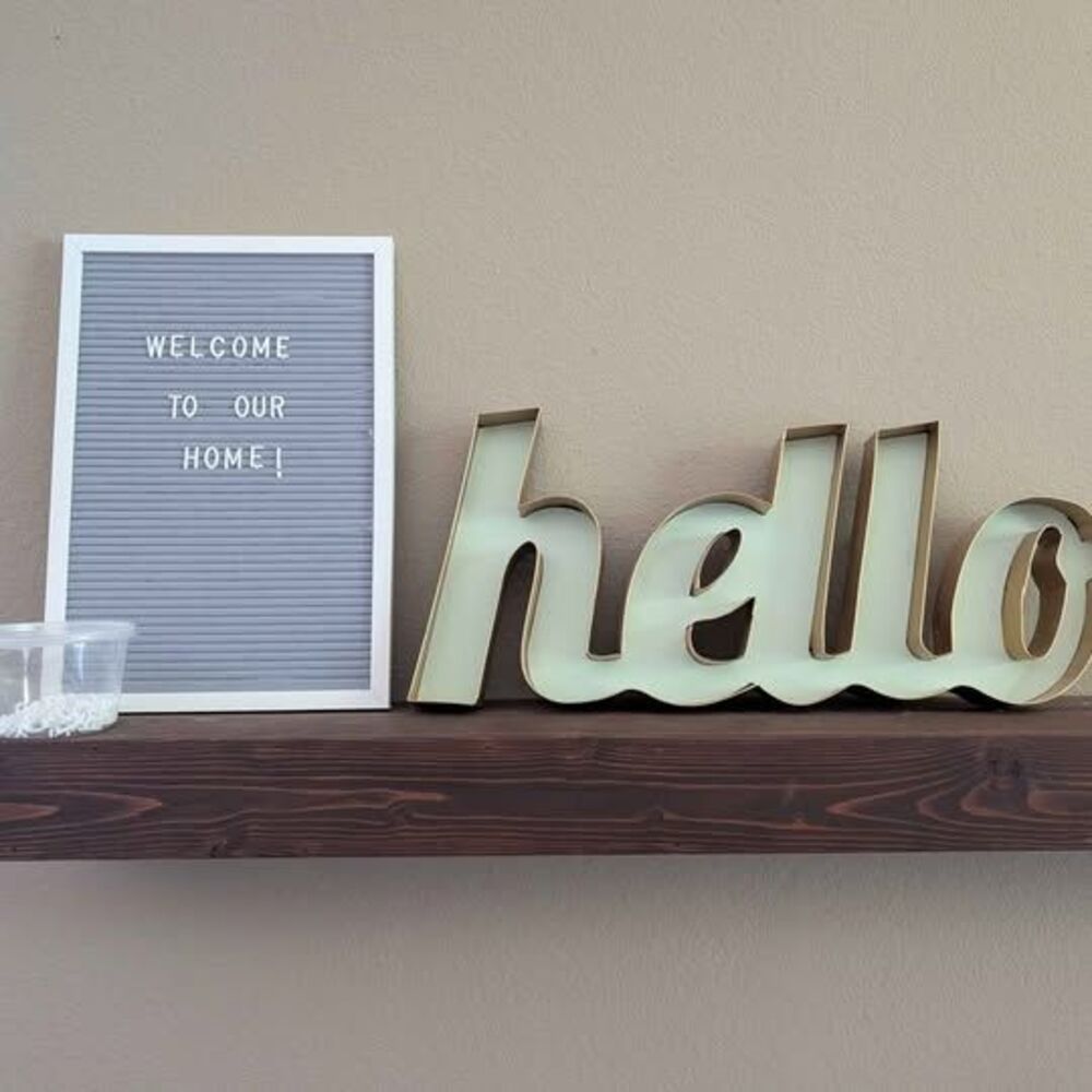 Light sage green and gold "Hello" metal sign